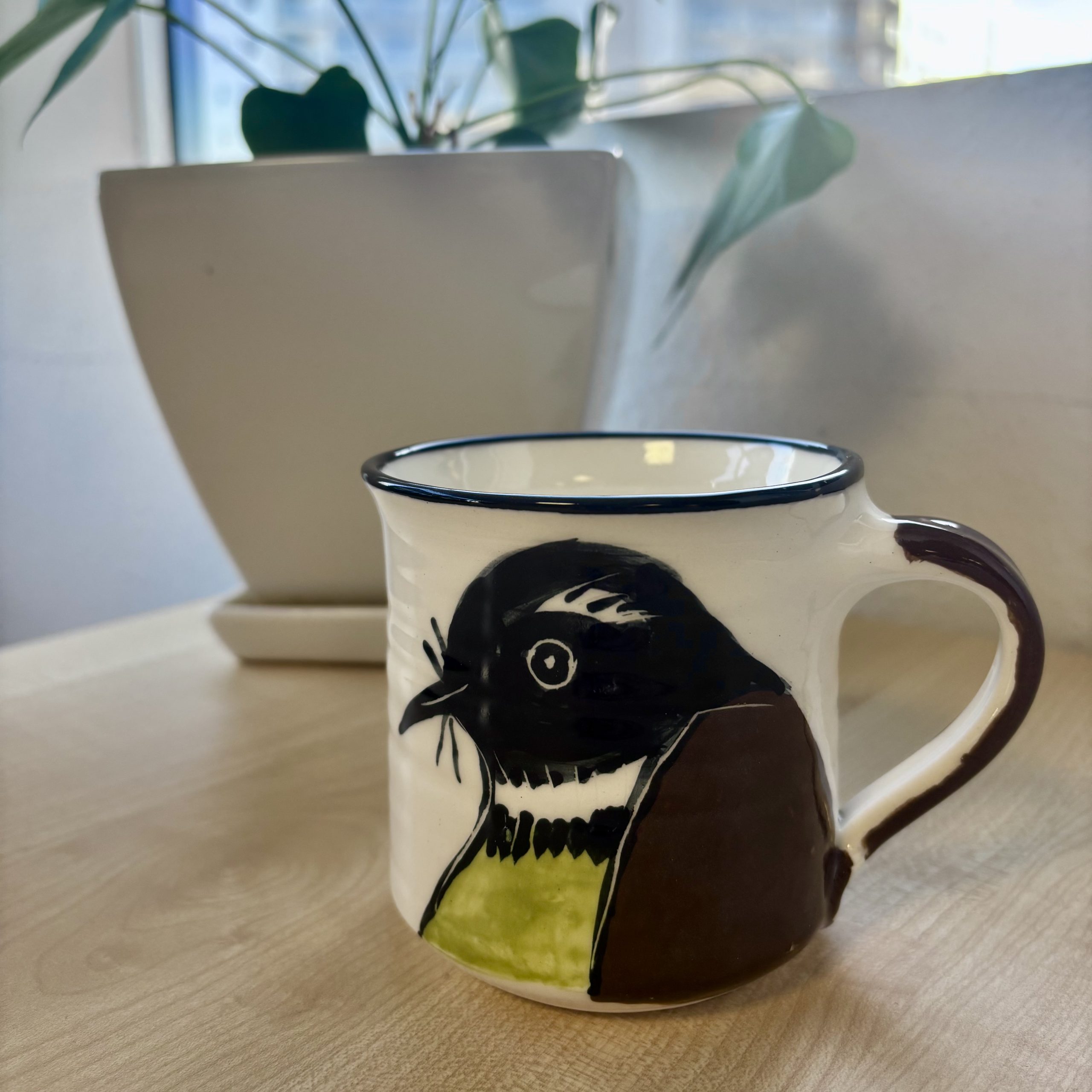 mug depicting piwakawaka bird