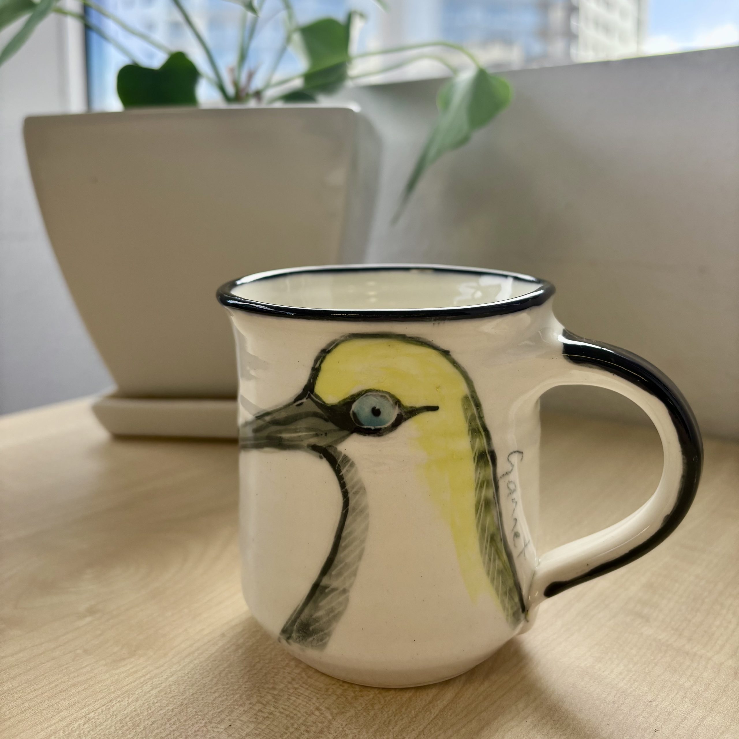 mug depicting takapu bird